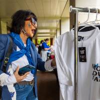 President Mantella looking at displays during Student Small Business Market.